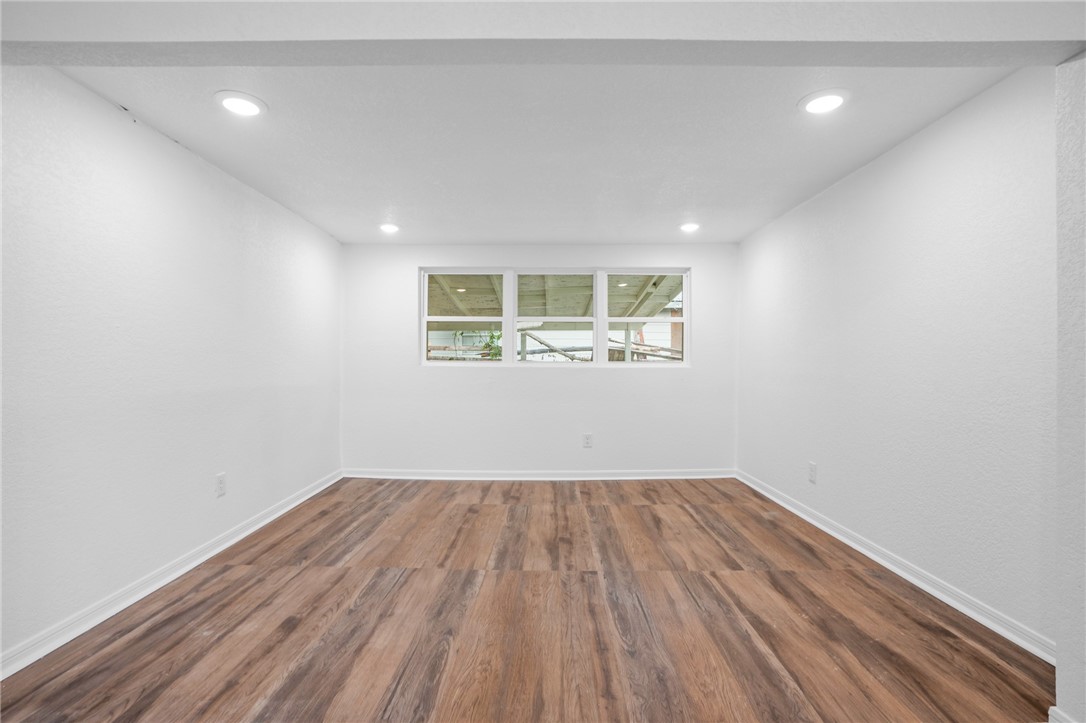 809 East Downs Avenue Temple, TX 76501 - Photo 7 of 24 an empty room with wooden floor and windows