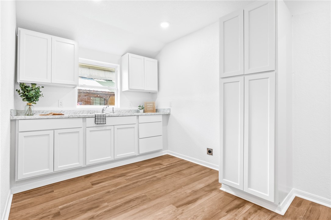 809 East Downs Avenue Temple, TX 76501 - Photo 9 of 24 a kitchen with white cabinets and white appliances