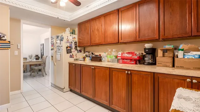 a kitchen with stainless steel appliances a sink a refrigerator and cabinets