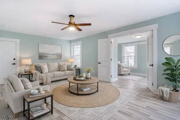a living room with furniture and a wooden floor