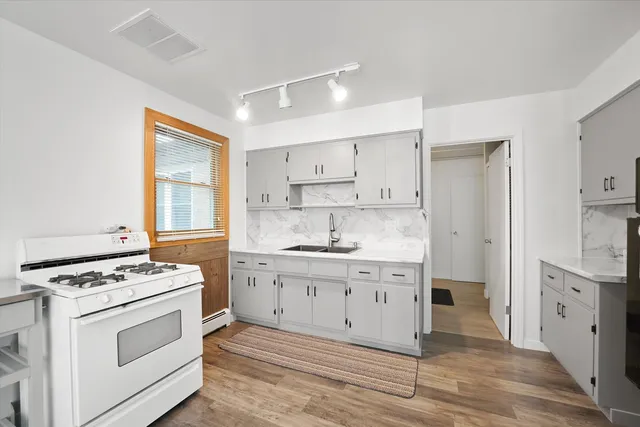 a kitchen with stainless steel appliances a stove microwave and cabinets