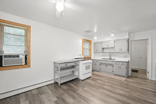 a kitchen with a stove a sink and a refrigerator