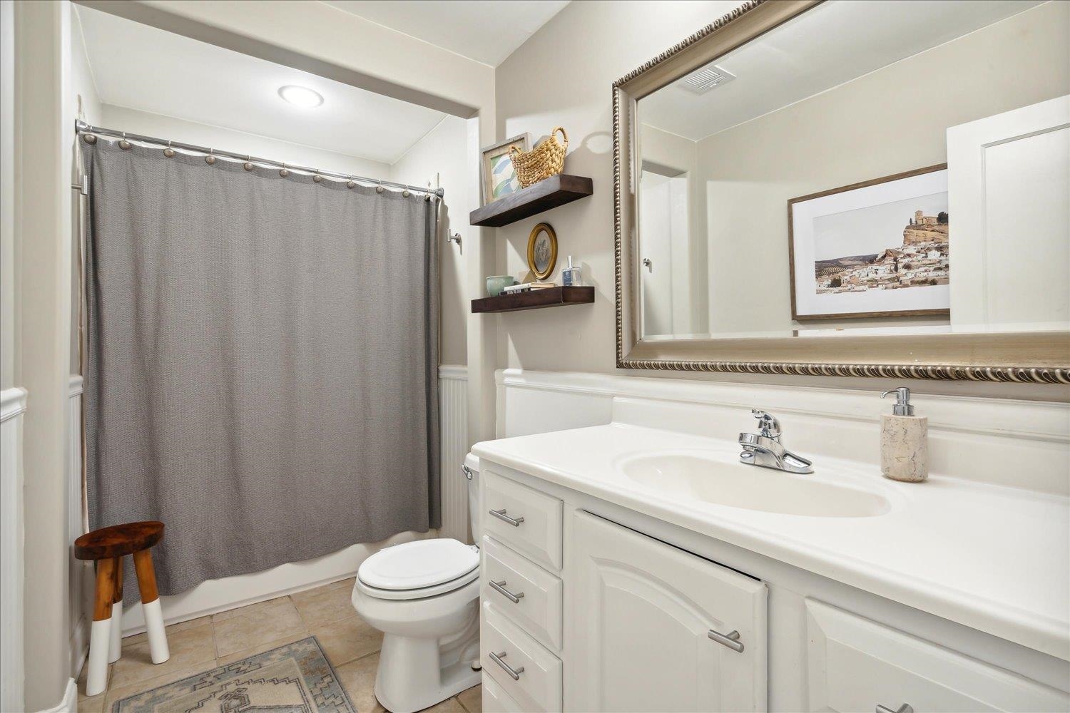 3569 Aurora Circle Memphis, TN 38111 - Photo 17 of 23 a bathroom with a sink a toilet and shower curtain