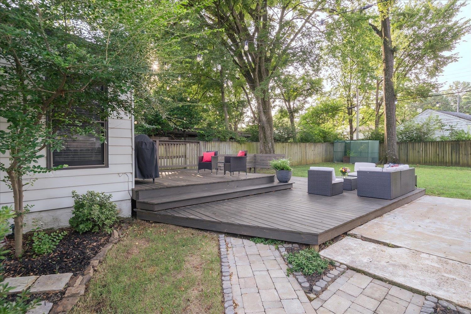 3569 Aurora Circle Memphis, TN 38111 - Photo 21 of 23 a view of a patio with table and chairs potted plants and large tree