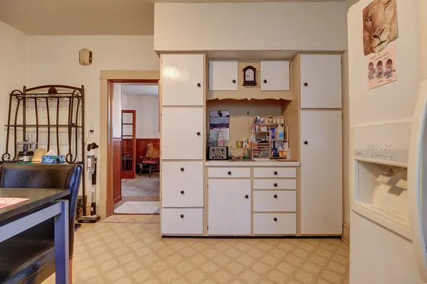 a kitchen with cabinets a washer and dryer