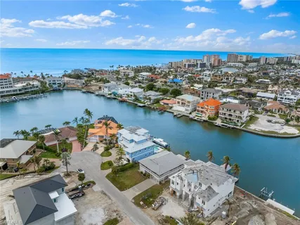 an aerial view of a houses with ocean view