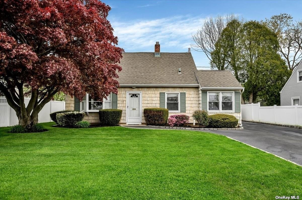 43 Blue Spruce Road Levittown, NY 11756 - Photo 1 of 1 a front view of a house with a garden