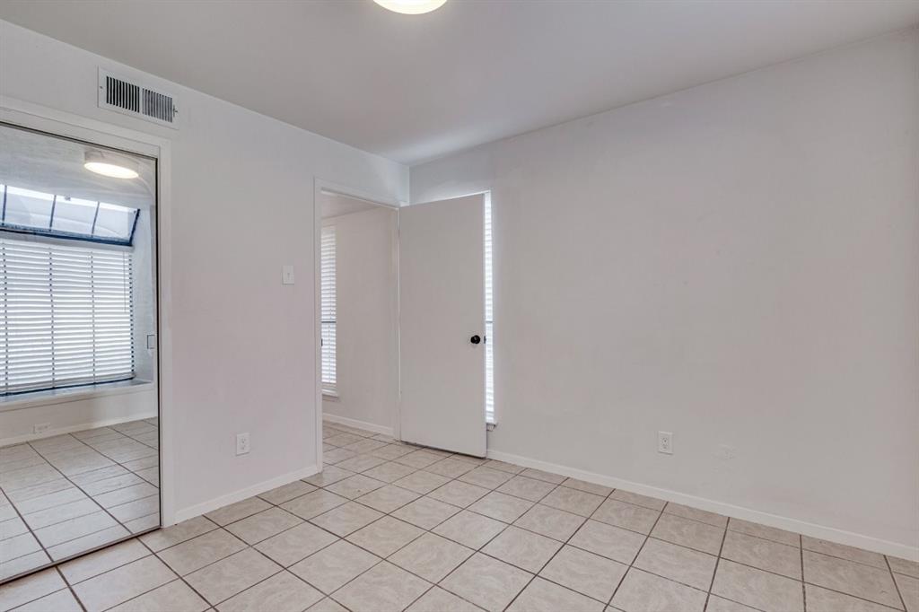 4606 Chaha Road, Unit 105 Garland, TX 75043 - Photo 18 of 26 Empty room featuring light tile patterned floors and baseboards