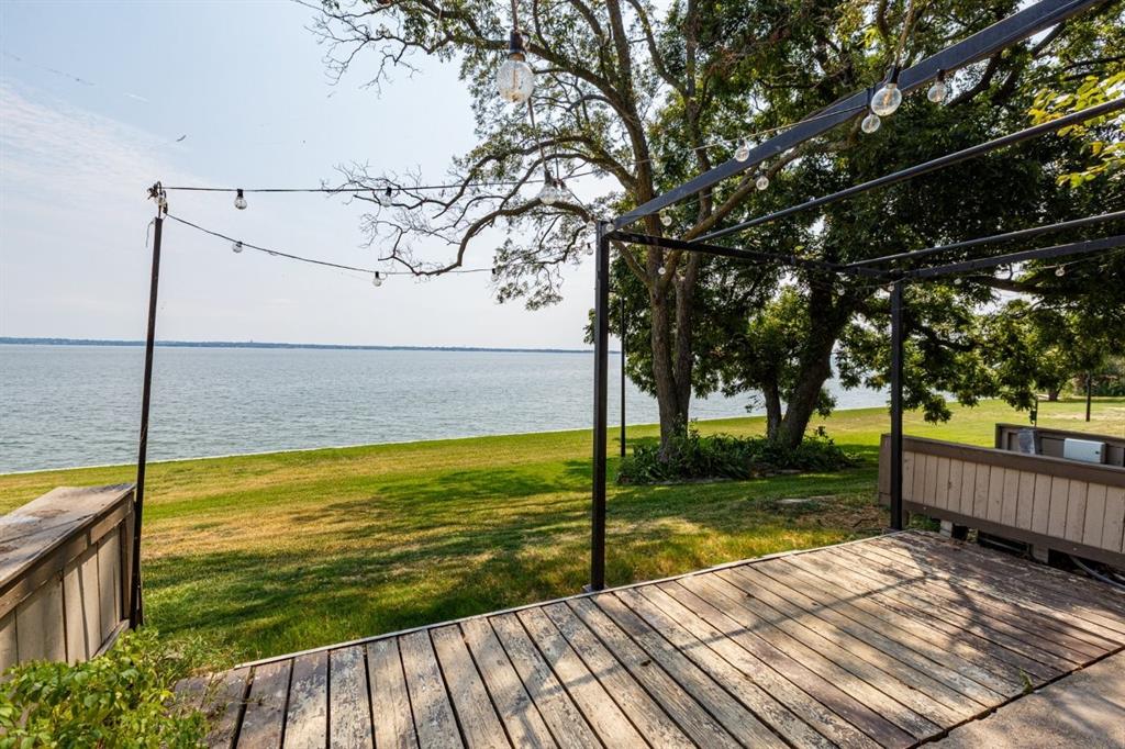 4606 Chaha Road, Unit 105 Garland, TX 75043 - Photo 22 of 26 Deck featuring a water view and a yard