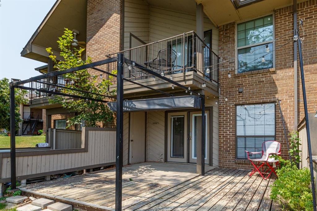 4606 Chaha Road, Unit 105 Garland, TX 75043 - Photo 26 of 26 Back of house with a balcony, brick siding, and a wooden deck