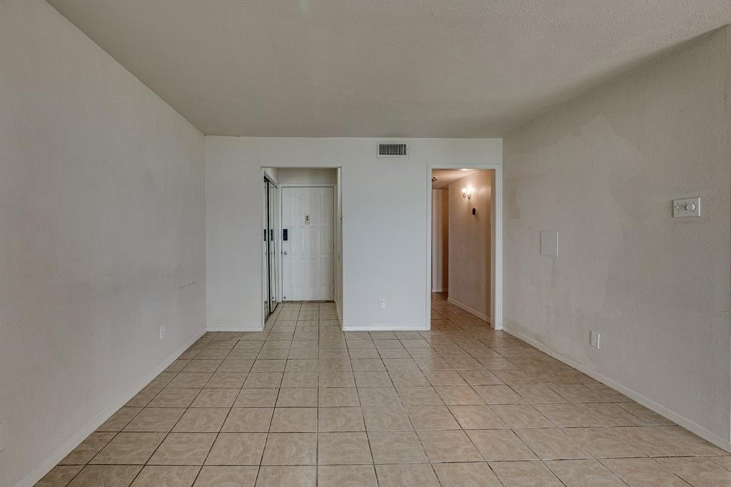 4606 Chaha Road, Unit 105 Garland, TX 75043 - Photo 7 of 26 Spare room featuring light tile patterned floors and baseboards