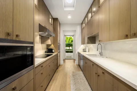 a large kitchen with a sink and cabinets