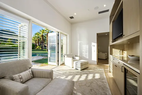 a living room with furniture and large windows