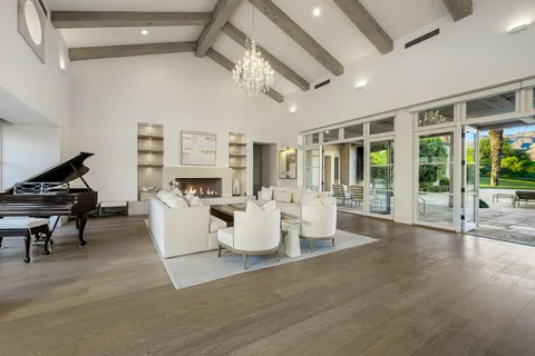 a living room with fireplace furniture and a wooden floor