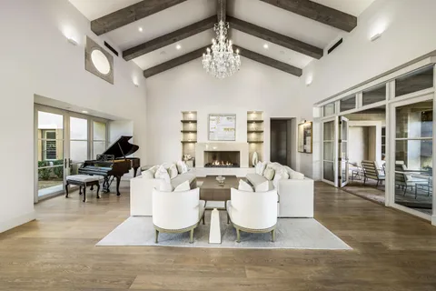 a living room with fireplace furniture and a chandelier