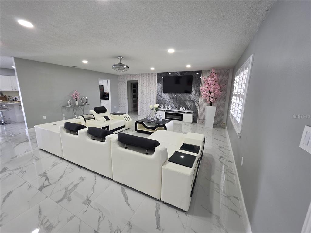 4821 Platt Road Plant City, FL 33565 - Photo 11 of 49 a living room with furniture a flat screen tv and a window