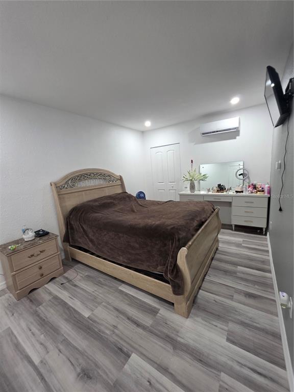 4821 Platt Road Plant City, FL 33565 - Photo 46 of 49 a bedroom with a bed and wooden floor