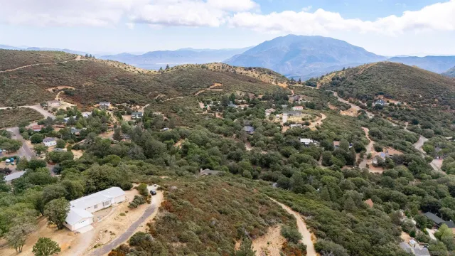 a view of a mountain range with lush green forest