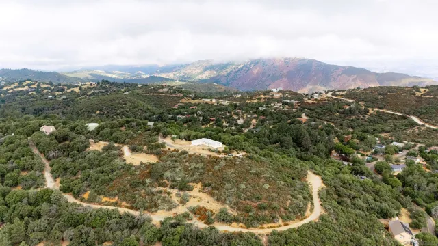a view of a mountain in the distance in a field
