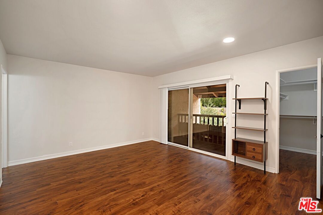 7774 Vía Rosa Maria Burbank, CA 91504 - Photo 13 of 22 a view of an empty room with wooden floor and closet