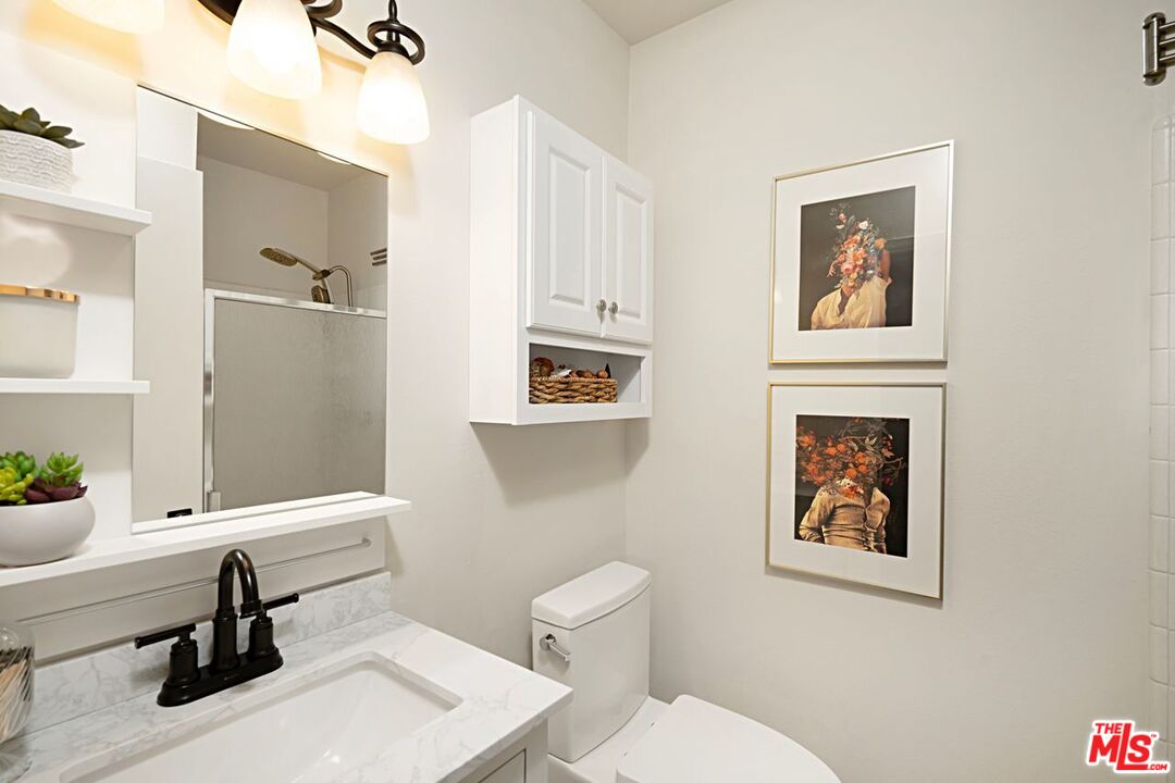 7774 Vía Rosa Maria Burbank, CA 91504 - Photo 15 of 22 a bathroom with a toilet a sink and mirror