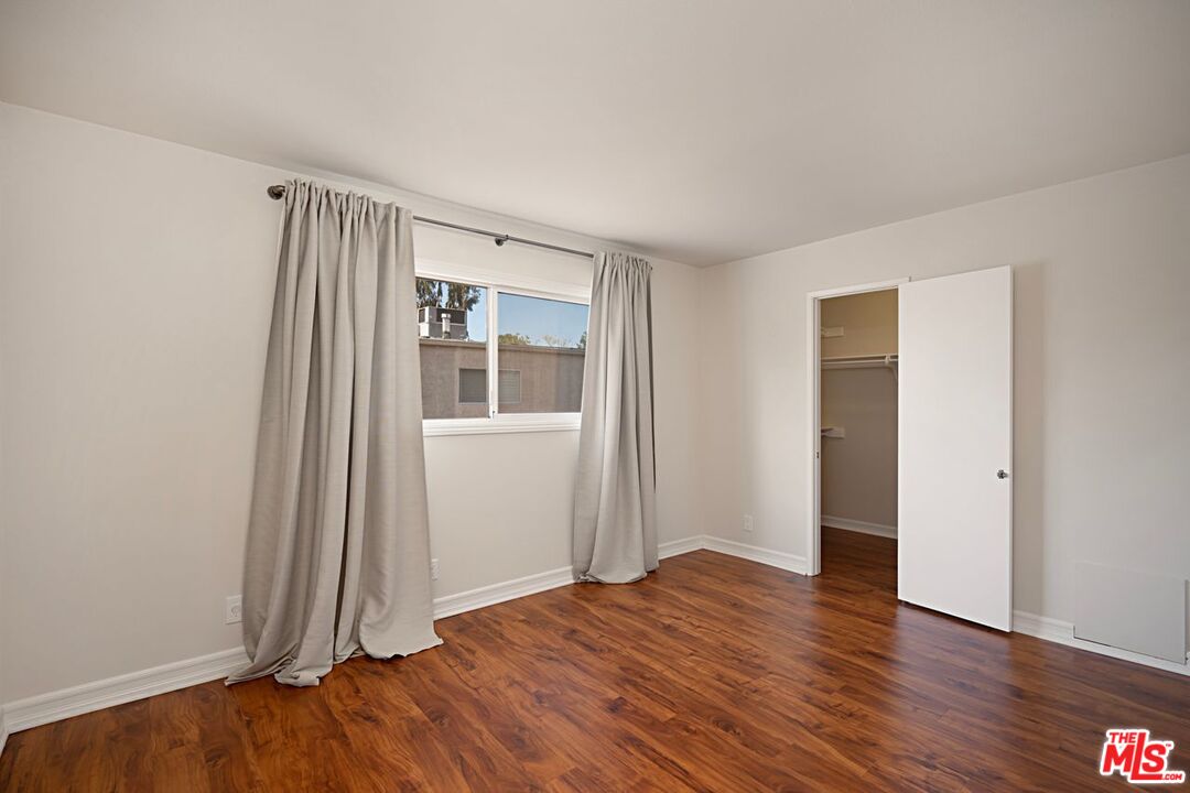 7774 Vía Rosa Maria Burbank, CA 91504 - Photo 17 of 22 an empty room with wooden floor and windows