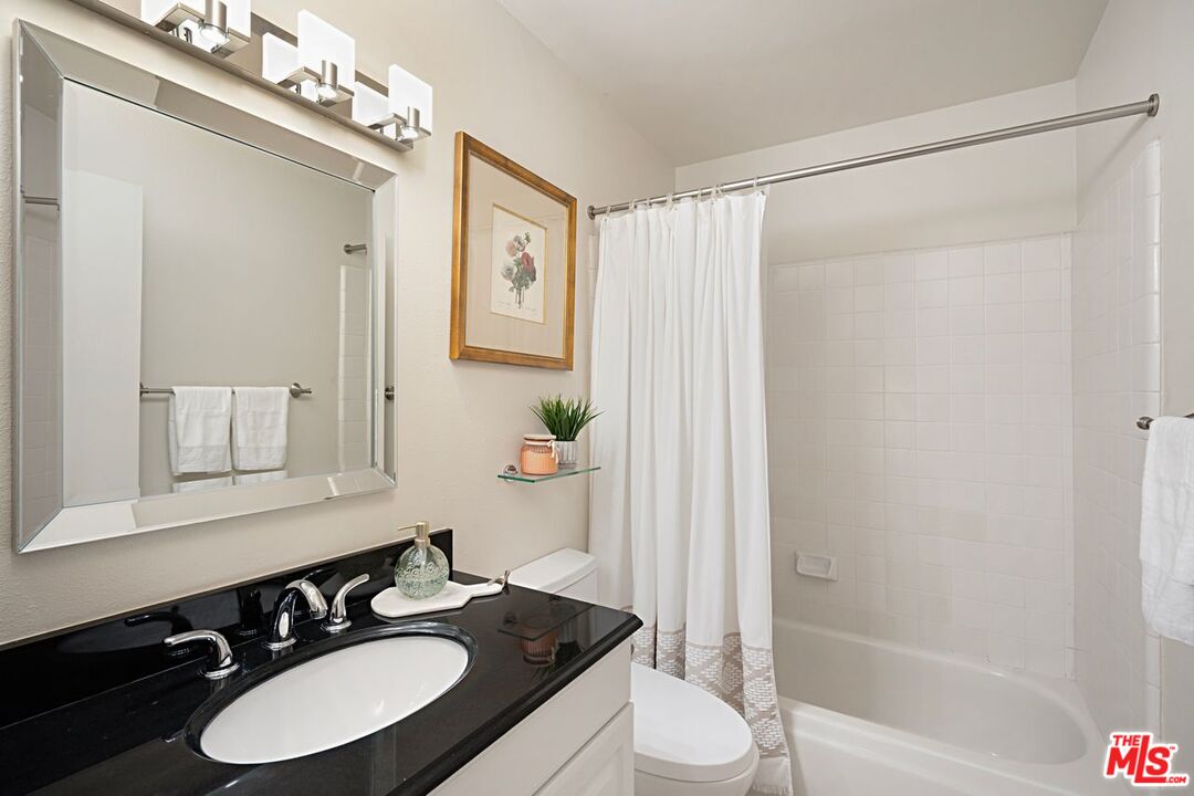 7774 Vía Rosa Maria Burbank, CA 91504 - Photo 19 of 22 a bathroom with a sink and a mirror