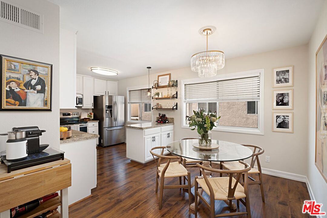 7774 Vía Rosa Maria Burbank, CA 91504 - Photo 5 of 22 a view of a dining room with furniture wooden floor and a chandelier