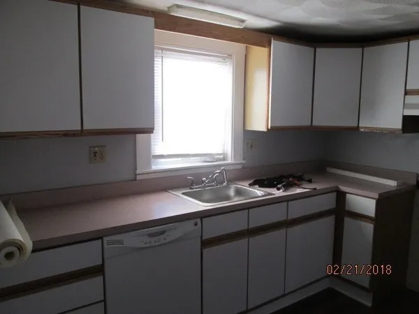 a kitchen with a sink cabinets and window