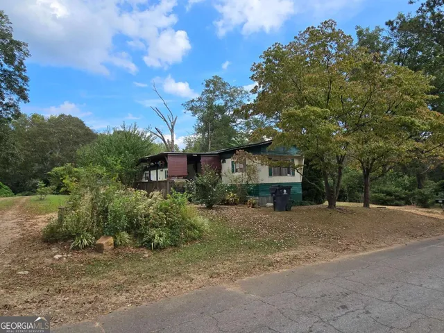 a view of a house with a tree in the background