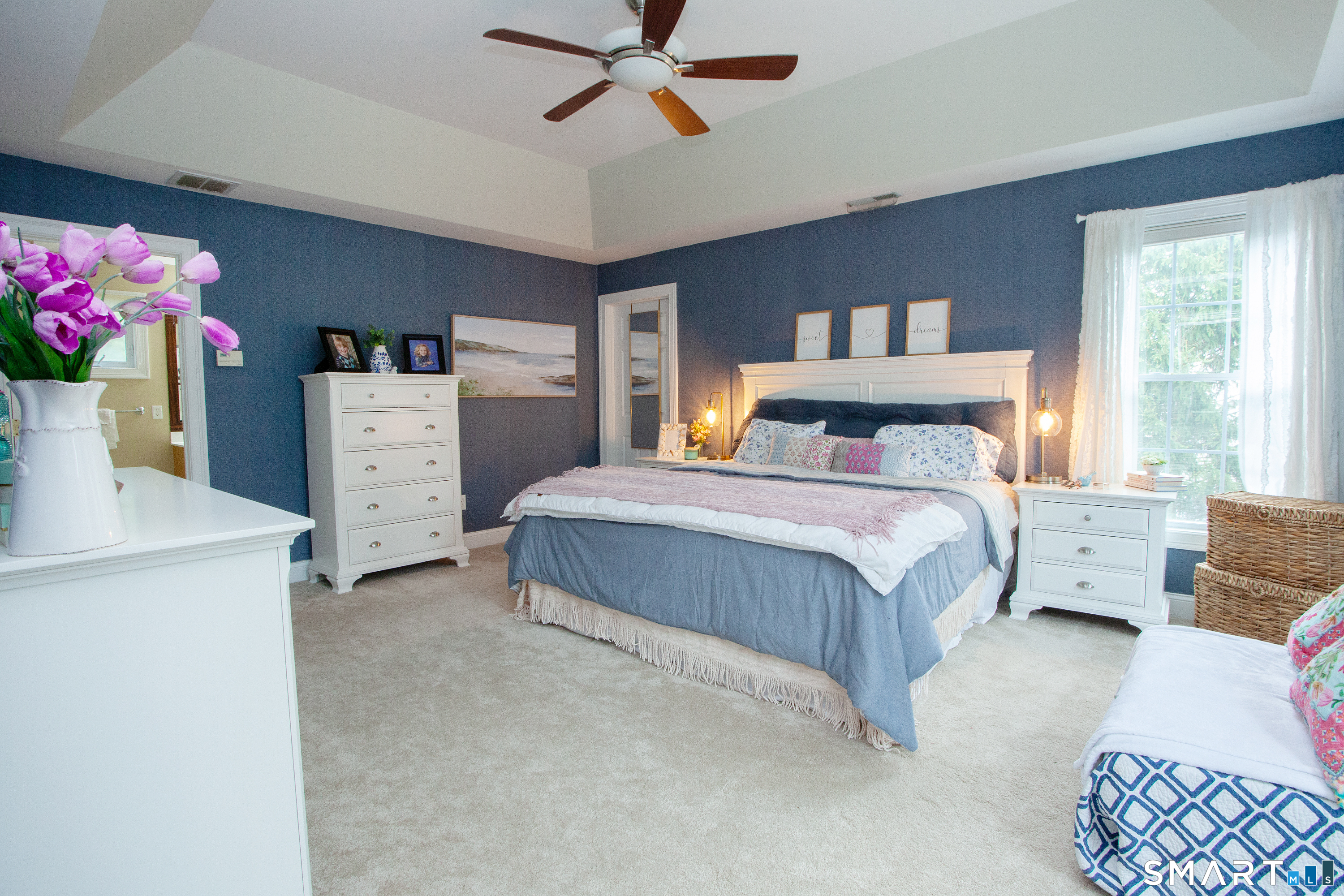 490 New Road Avon, CT 06001 - Photo 18 of 30 a bedroom with a bed and a chandelier