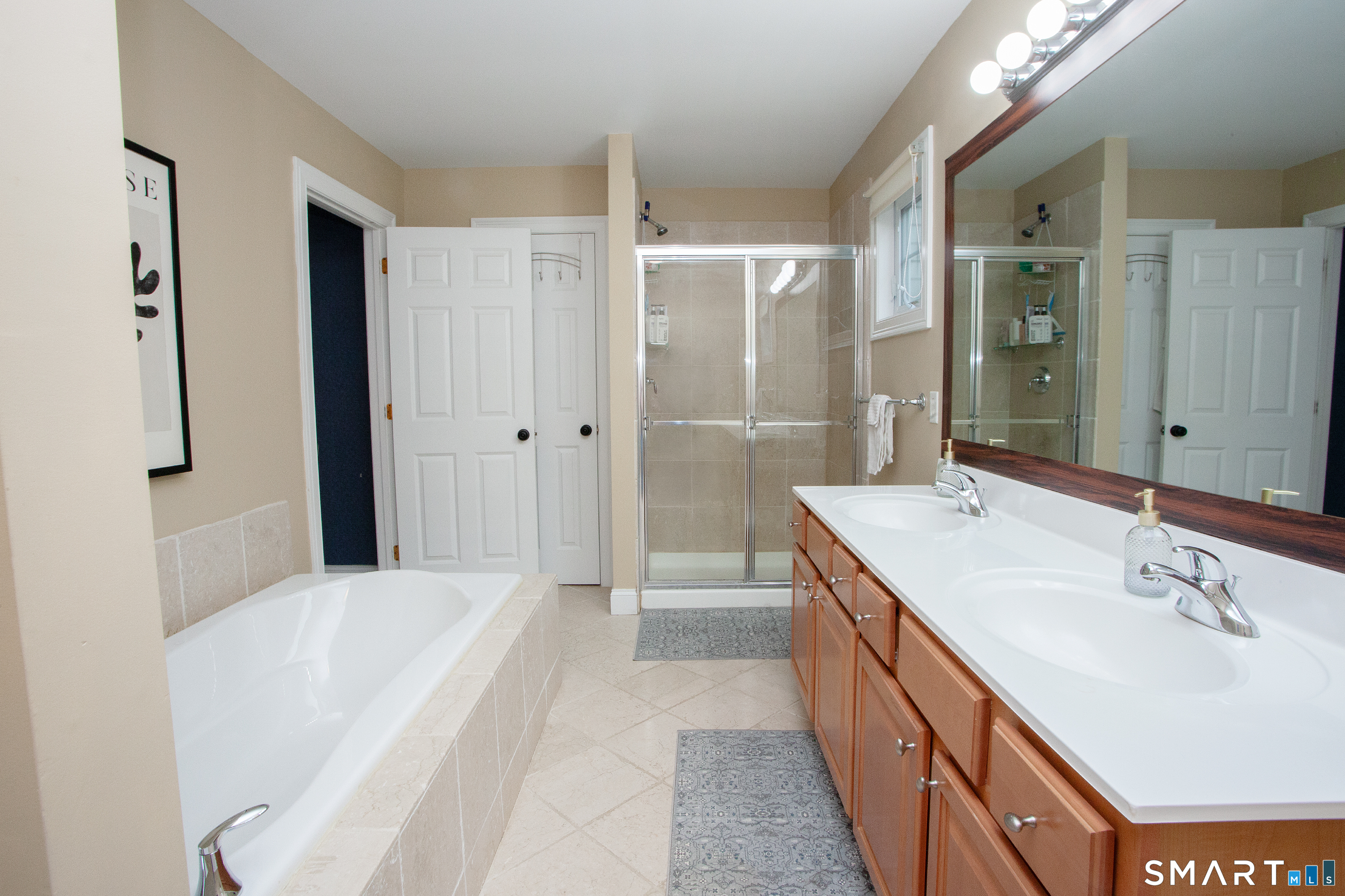 490 New Road Avon, CT 06001 - Photo 20 of 30 a spacious bathroom with a bathtub shower sink double and mirror