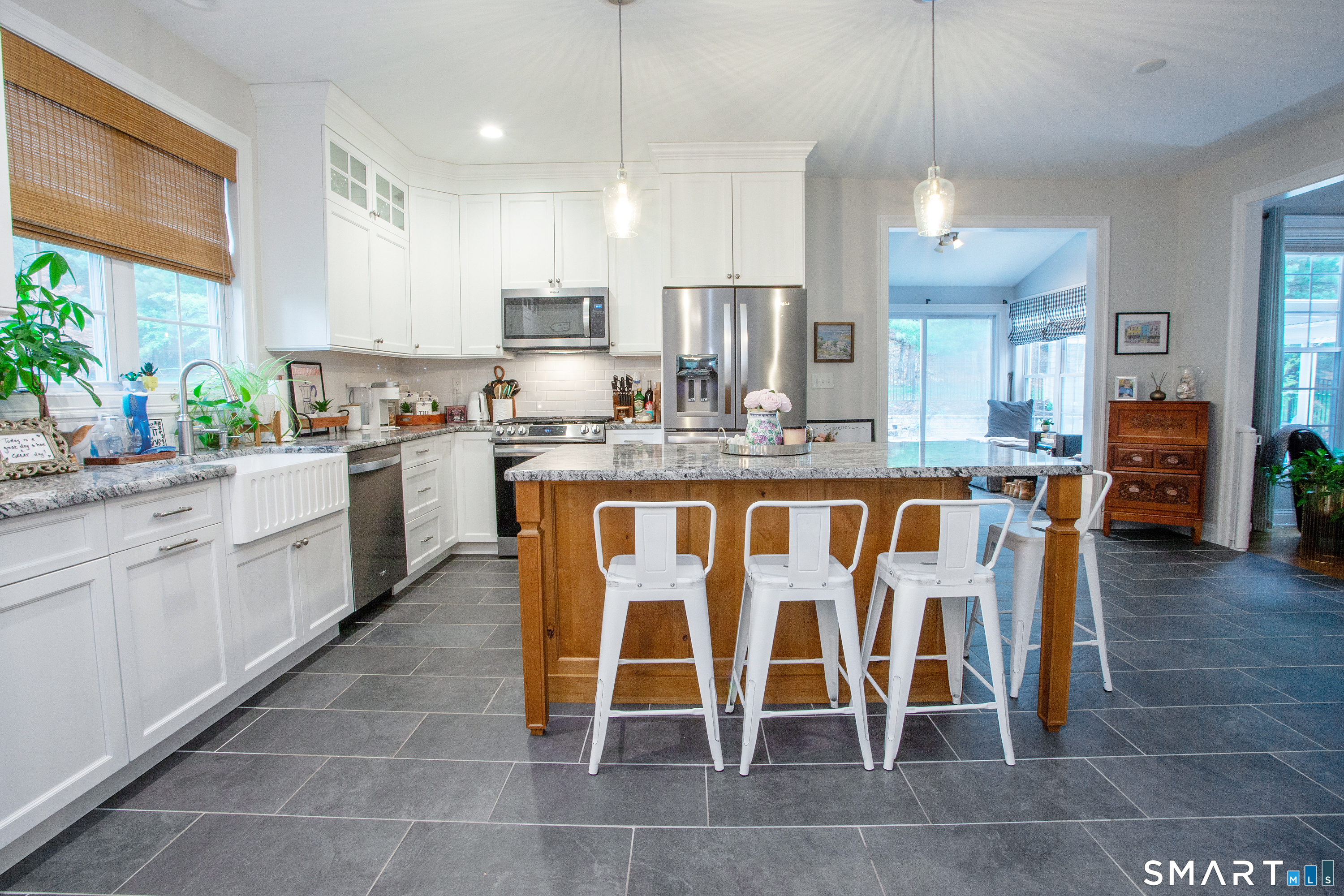 490 New Road Avon, CT 06001 - Photo 4 of 30 a kitchen with stainless steel appliances granite countertop a table chairs sink and cabinets