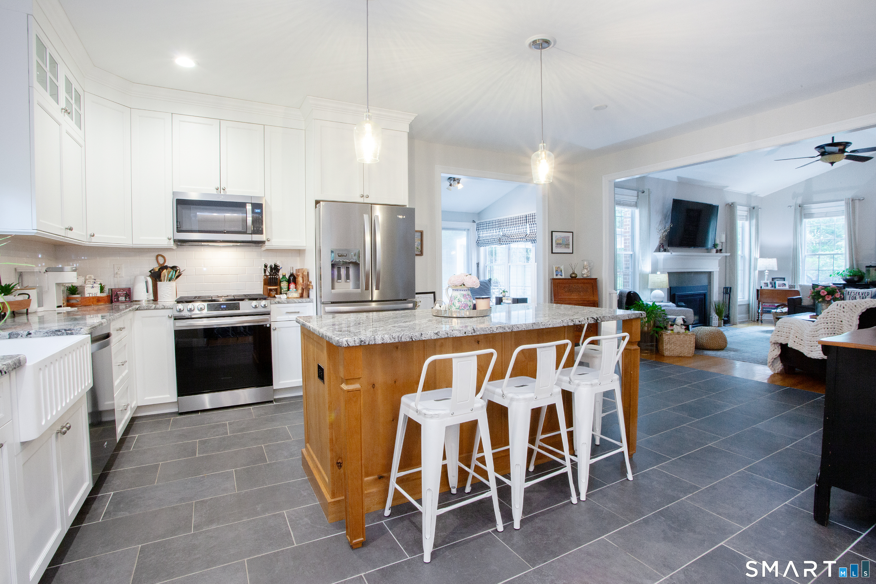 490 New Road Avon, CT 06001 - Photo 5 of 30 a kitchen with stainless steel appliances granite countertop a stove top oven a sink dishwasher a dining table and chairs