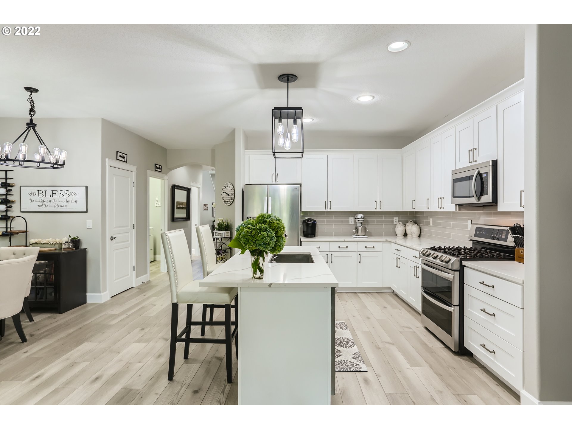 16603 Southwest 134th Terrace Portland, OR 97224 - Photo 11 of 30 a kitchen with white cabinets and stainless steel appliances
