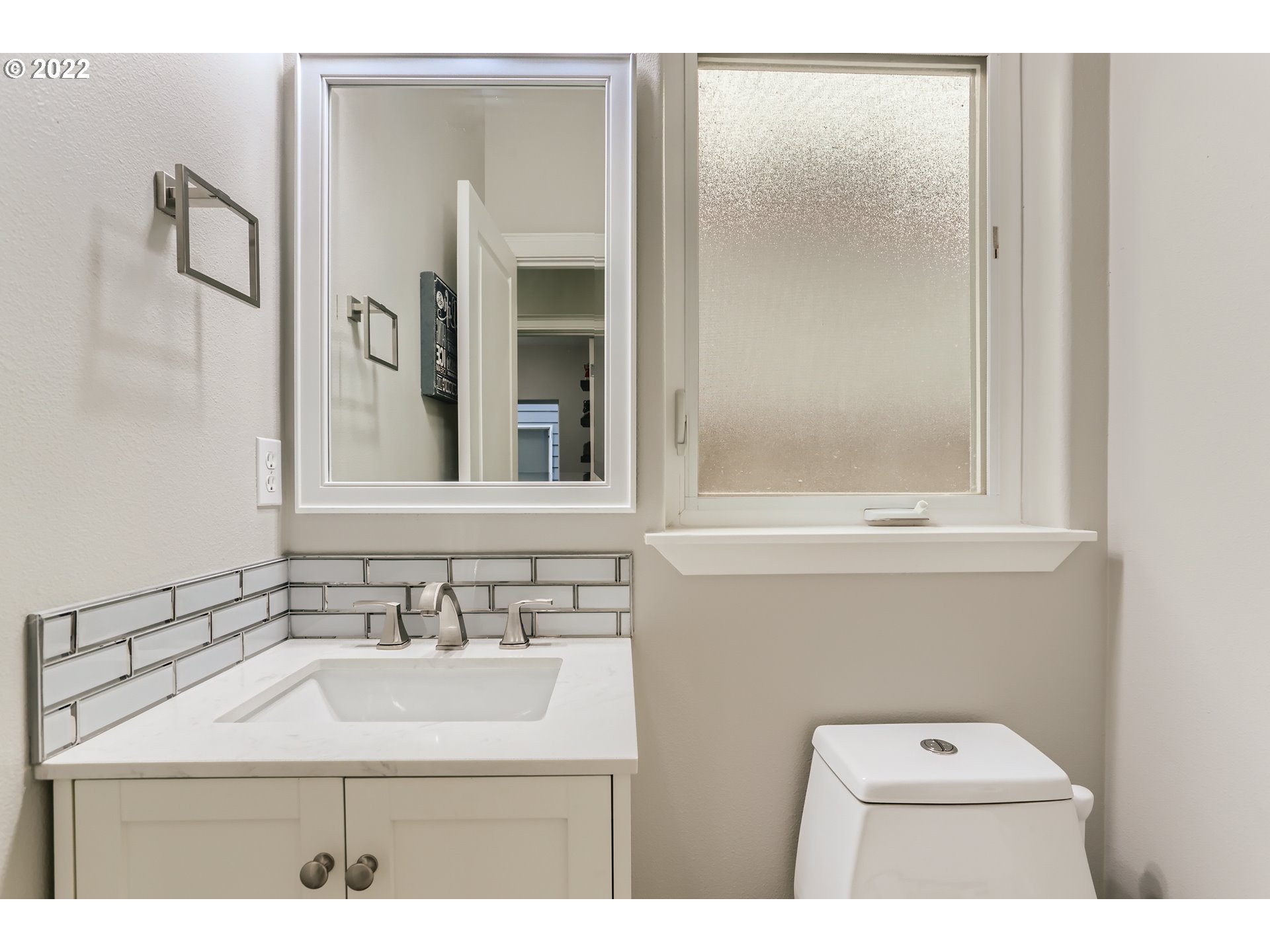 16603 Southwest 134th Terrace Portland, OR 97224 - Photo 14 of 30 a bathroom with a sink a toilet a mirror and shower