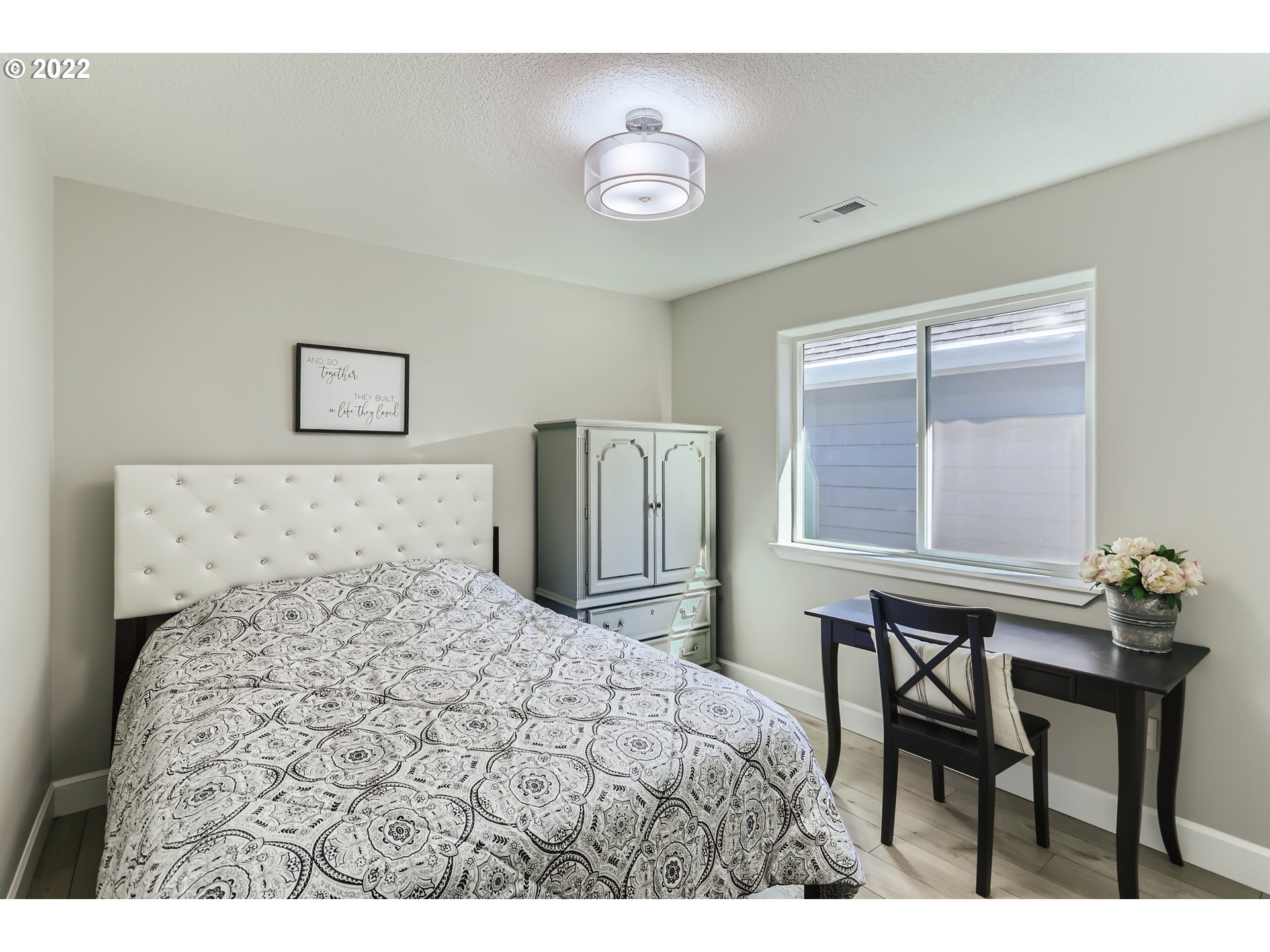16603 Southwest 134th Terrace Portland, OR 97224 - Photo 22 of 30 a bedroom with a bed and a table in it