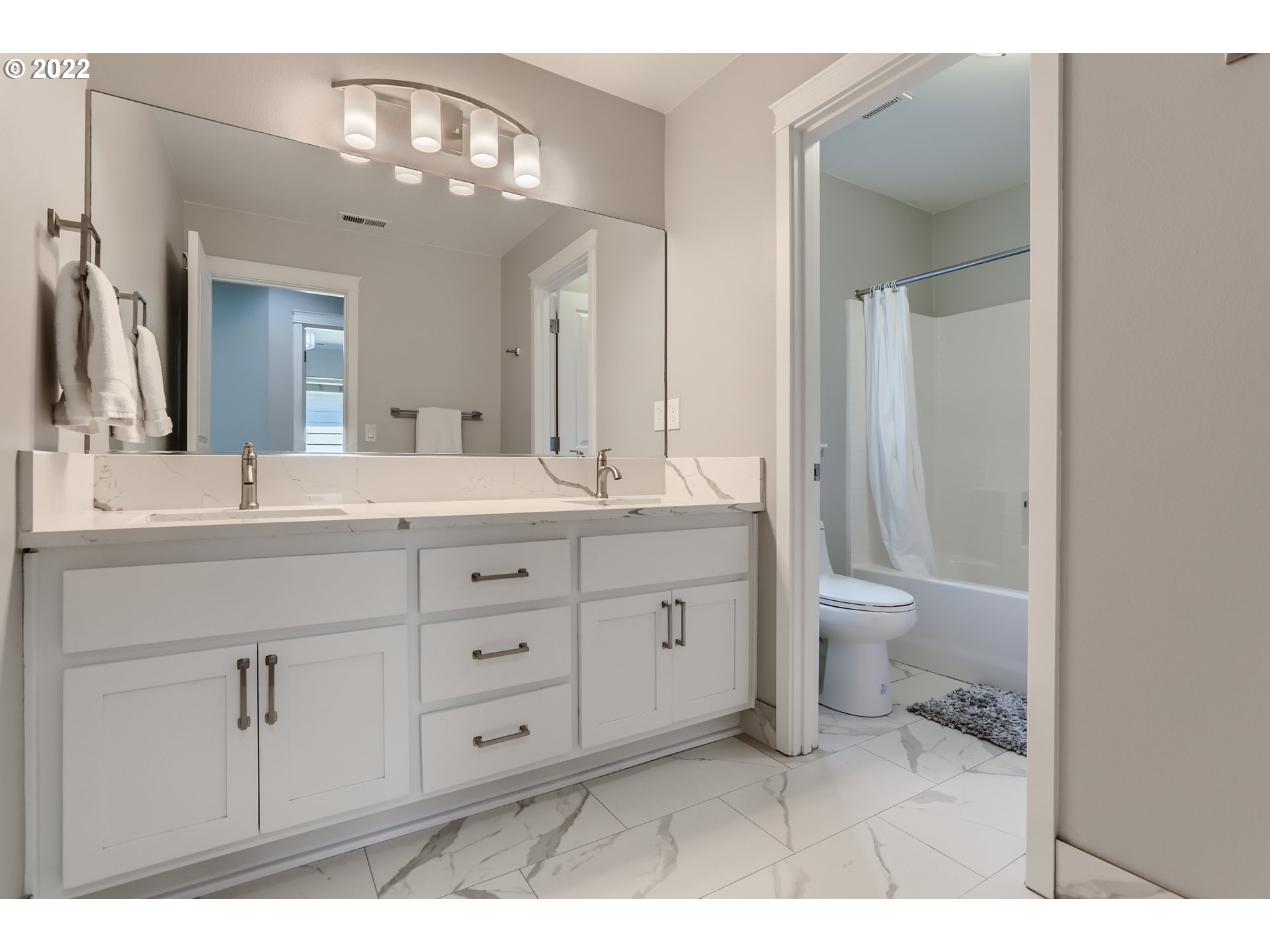 16603 Southwest 134th Terrace Portland, OR 97224 - Photo 24 of 30 a bathroom with a granite countertop sink a toilet and a mirror