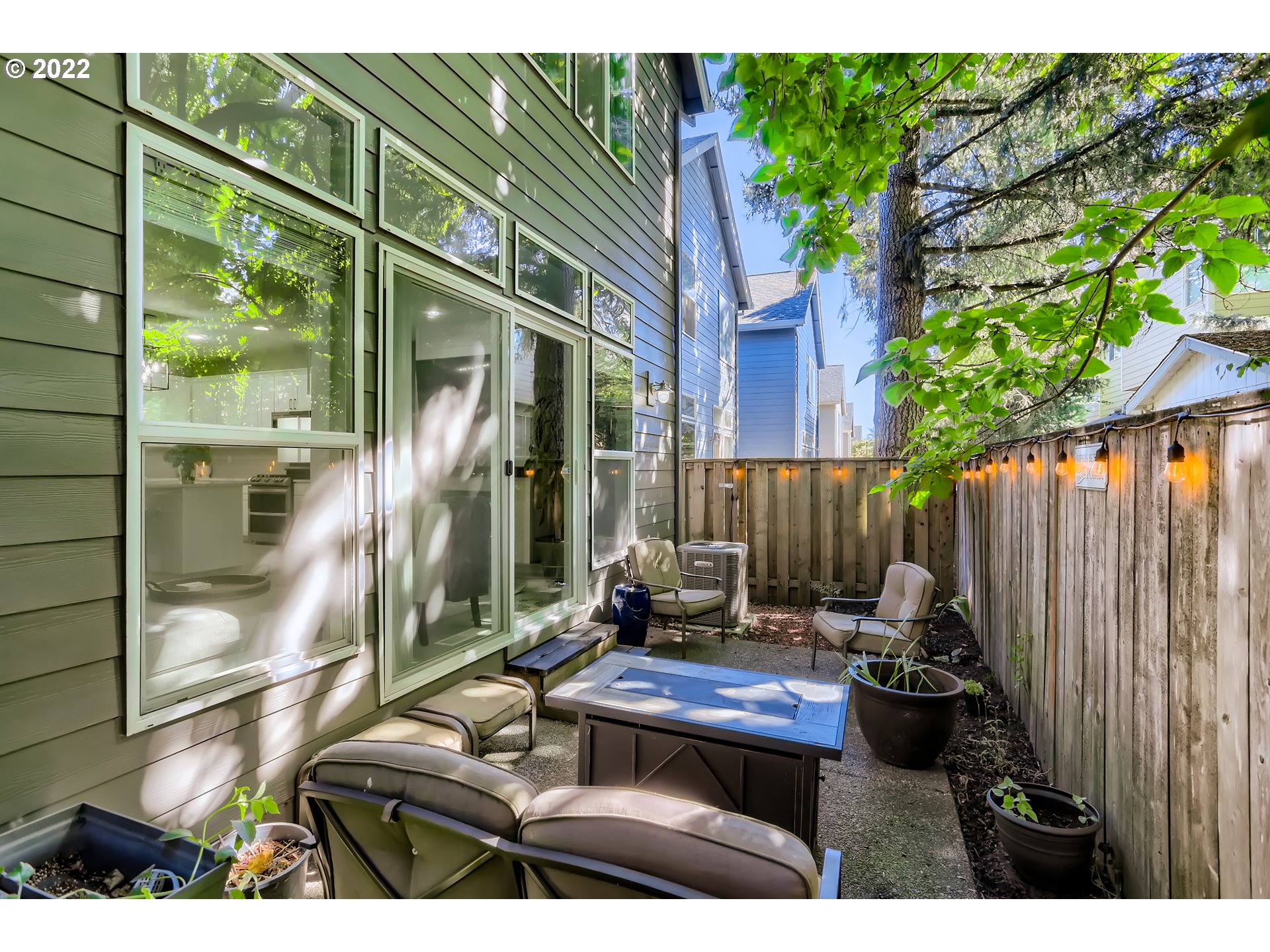 16603 Southwest 134th Terrace Portland, OR 97224 - Photo 28 of 30 a view of backyard with a table and chairs and potted plants