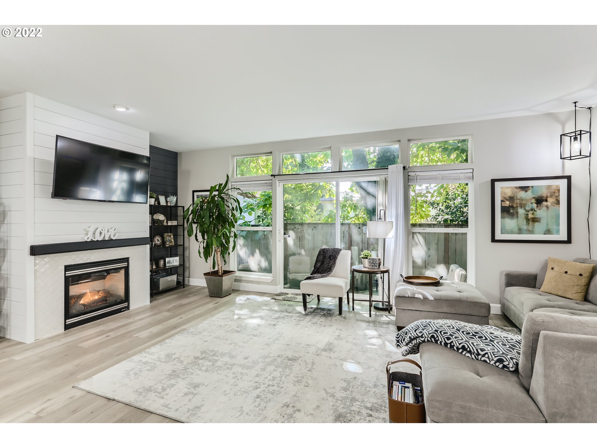 16603 Southwest 134th Terrace Portland, OR 97224 - Photo 8 of 30 a living room with furniture a flat screen tv and a fireplace