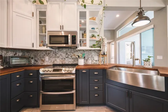 a kitchen with stainless steel appliances granite countertop a stove and a microwave