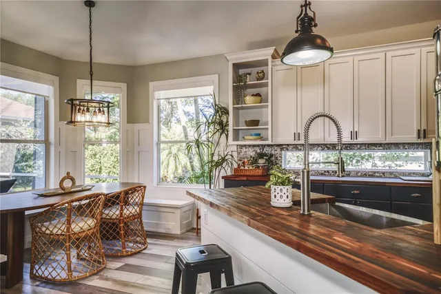 a kitchen with sink refrigerator and window