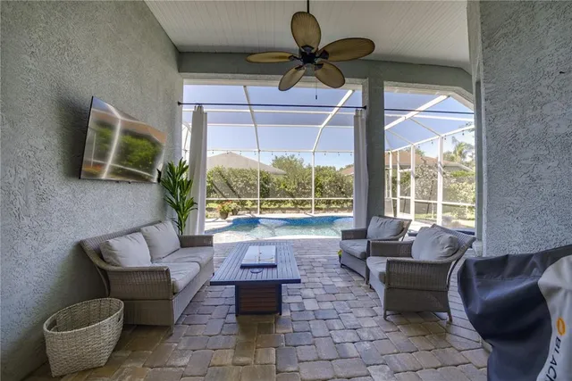 a living room with furniture and a floor to ceiling window