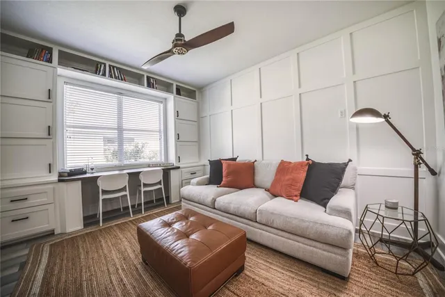 a living room with furniture and next to a window