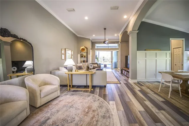 a living room with furniture a rug and white walls