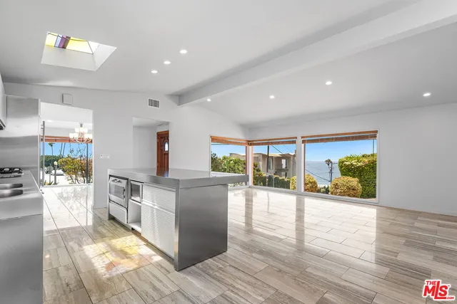 a kitchen with stainless steel appliances granite countertop a stove and a wooden floors