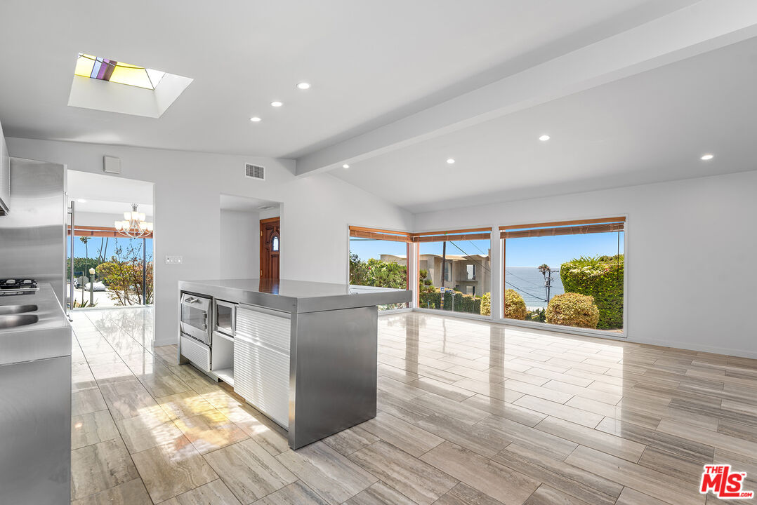 7220 Rindge Avenue Playa del Rey, CA 90293 - Photo 11 of 53 a kitchen with stainless steel appliances granite countertop a stove and a wooden floors