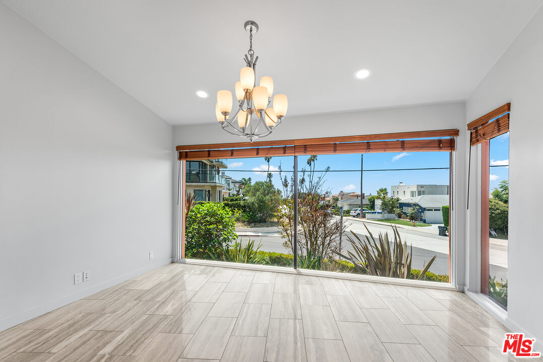 7220 Rindge Avenue Playa del Rey, CA 90293 - Photo 13 of 53 a view of a dining room with furniture a chandelier and large windows