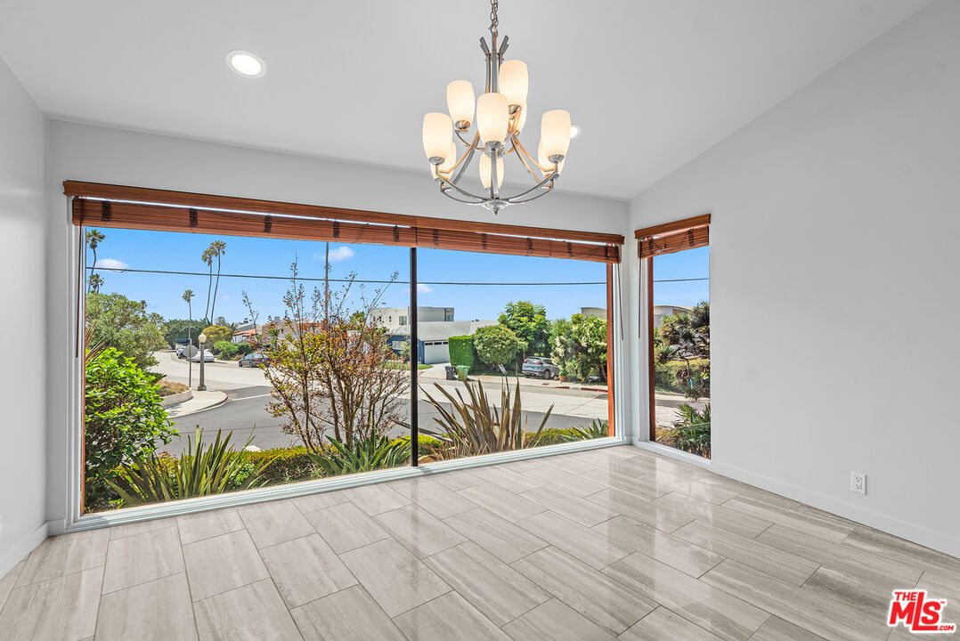 7220 Rindge Avenue Playa del Rey, CA 90293 - Photo 14 of 53 a view of a room with wooden floor and a chandelier