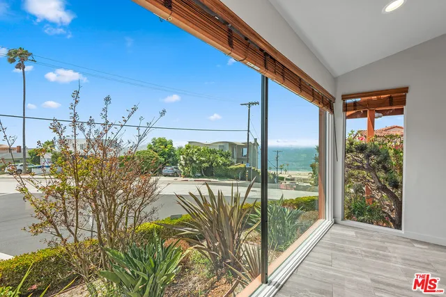 a view of a floor to ceiling window and wooden floor